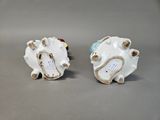 two white and blue vases sitting on a table