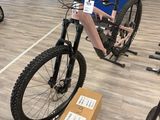 a man sitting on a bike in a bike shop