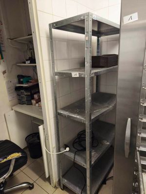 a kitchen with a metal shelving and lots of shelves