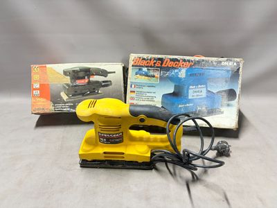 the yellow sander is sitting next to a box of power tools