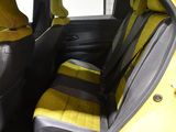 a yellow car with yellow seats in the back of it