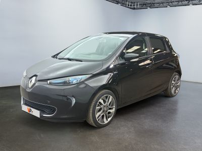 the small car is parked in a large room with a black floor
