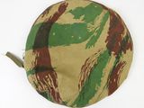 a close up of a camouflage hat on a white surface