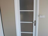 a white door in a room with a black carpet
