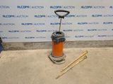 a picture of an orange and black machine with a wooden handle