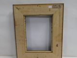 an old picture frame sitting on top of a white table