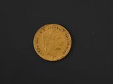 an image of a gold coin on a black surface