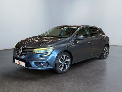 a grey car is parked in a room with a white wall