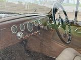 a dashboard of a car with a steering wheel and gauges