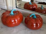 four tomatoes sitting on a counter in front of a mirror