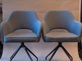 two chairs sitting next to each other in a room