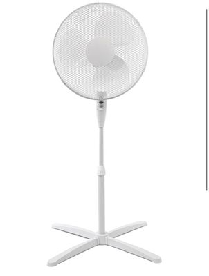 a white fan sitting on top of a metal stand next to a white wall
