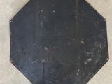 a black stop sign that is on the ground