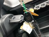 a car key in the center of a car with a sticker attached to it