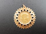 a close up of a gold coin with a woman ' s face on it