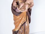 statue of jesus holding a child in his arms on a marble base