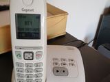 a white phone sitting on top of a desk next to a box
