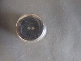a close up of a small silver object on a table