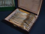 a lot of silverware in a box on a table
