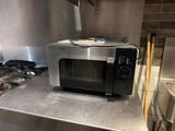 a microwave that is sitting on a counter in a kitchen