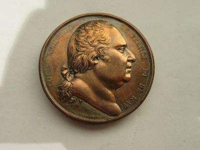 une vieille pièce de monnaie sur laquelle figure le portrait d'un homme