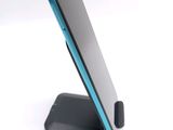 a phone that is sitting on a stand on a table