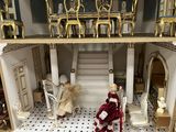 a doll house with a staircase and a staircase leading up to the second floor