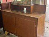 a wooden cabinet with a fish tank on top of it