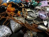 a black table topped with assorted jewelry on it