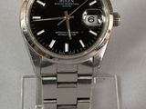a watch that is sitting on a clear stand