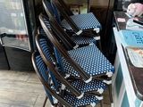 a lot of chairs that are sitting in front of a refrigerator