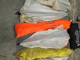 several umbrellas are lined up on the ground in a parking lot