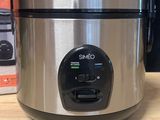 a crock pot sitting on a table next to a box of food