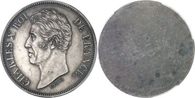 a close up of a coin on a white surface with a white background