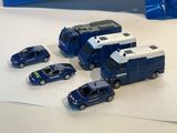 four toy cars that are sitting on a table