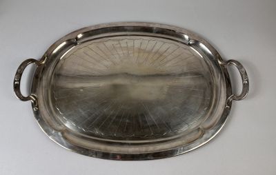 a silver tray with a handle on a white table