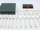 a lot of silverware on a table with a box
