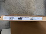 an open box with a barcode on it sitting on top of a cardboard box