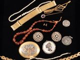 several pieces of jewelry are displayed on a black surface