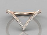 a rose gold ring with diamonds on top of it