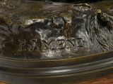 a bronze statue of a horse on a wooden table