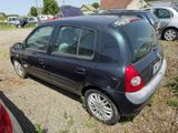 a small black car that is parked in a lot