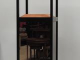 a black and wooden display case with a mirror on it