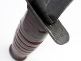 a close up of a knife on a white surface