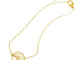 a gold plated necklace with a white shell on a chain