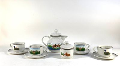 five cups and a teapot sitting on a table