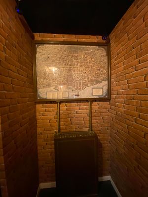 a suitcase sitting in the corner of a room with brick walls