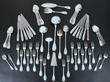 a lot of silver spoons and forks arranged in a circle