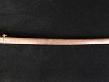 a close up of a sword on a black surface