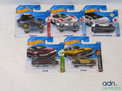 five hot wheels cars on display on a table